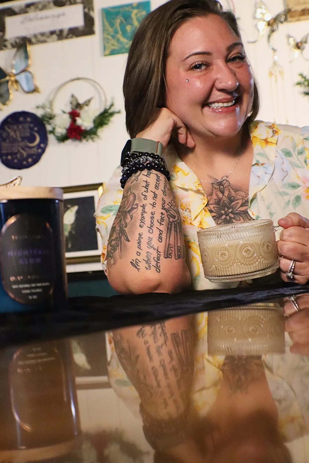 Desarae smiling with a coffee in her warmly decorated studio